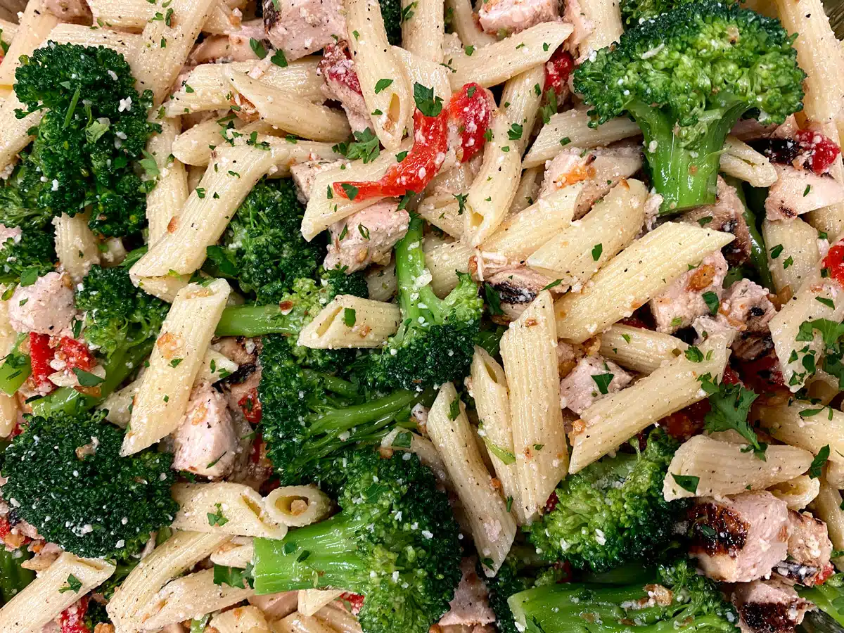 Fresh penna pasta with chicken, broccoli, roasted red peppers, and parmesan cheese