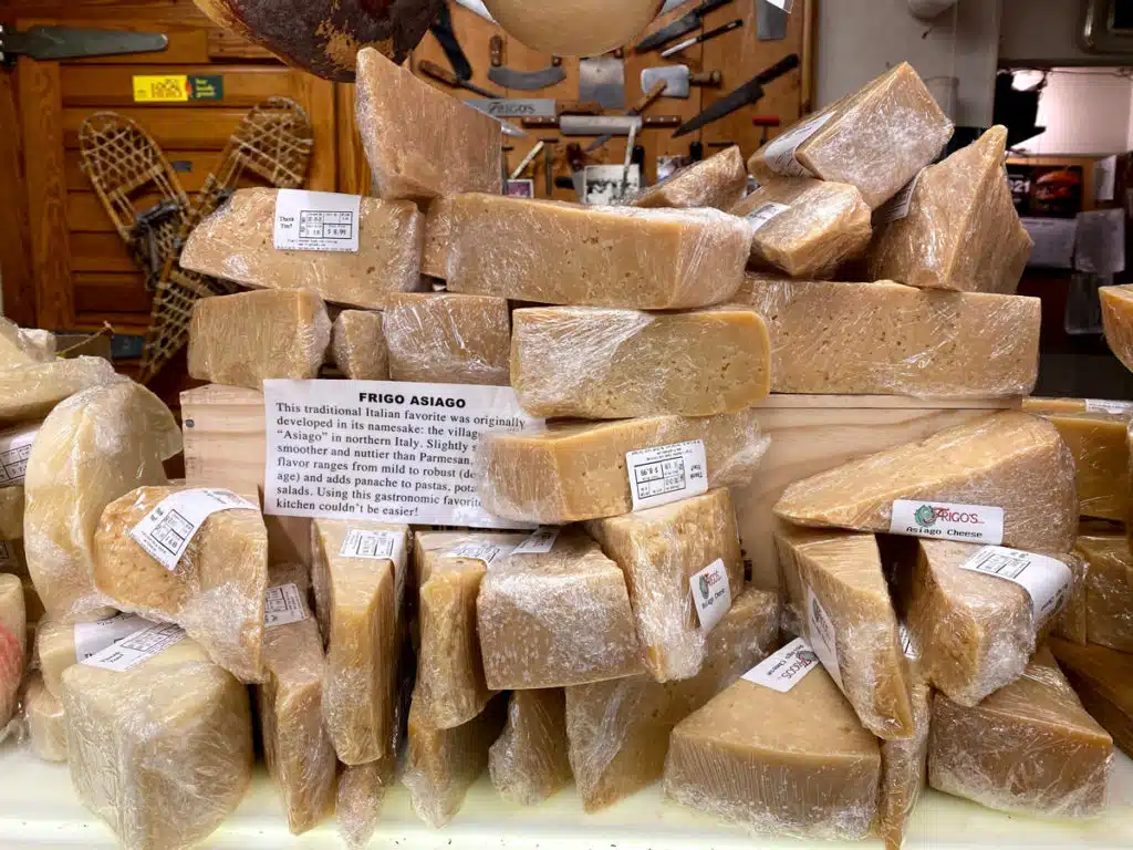 Italian Asiago cheese chopped from a full wheel