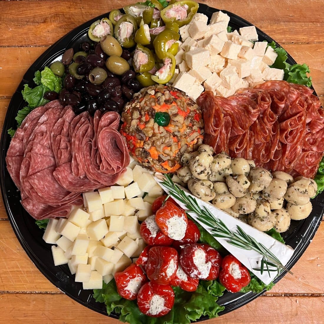 Antipasto platter with salami, cheeses, olives, marinated mushrooms and stuffed peppers