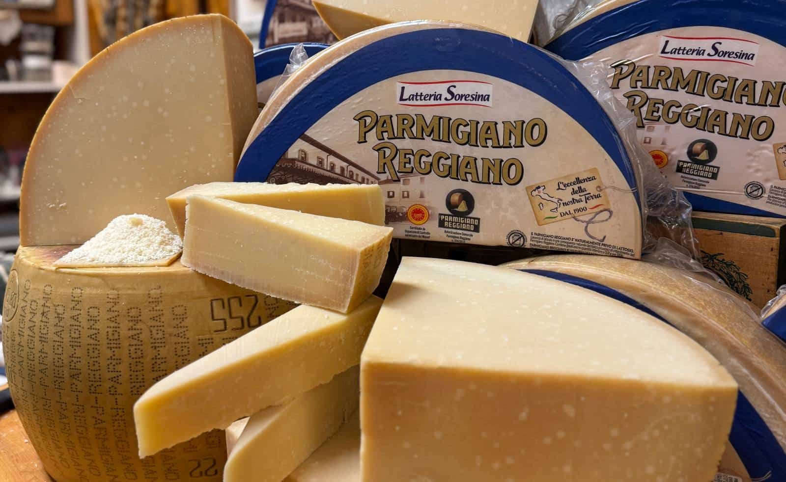 Wheels and wedges of Parmigiano Reggiano on the Frigo's counter