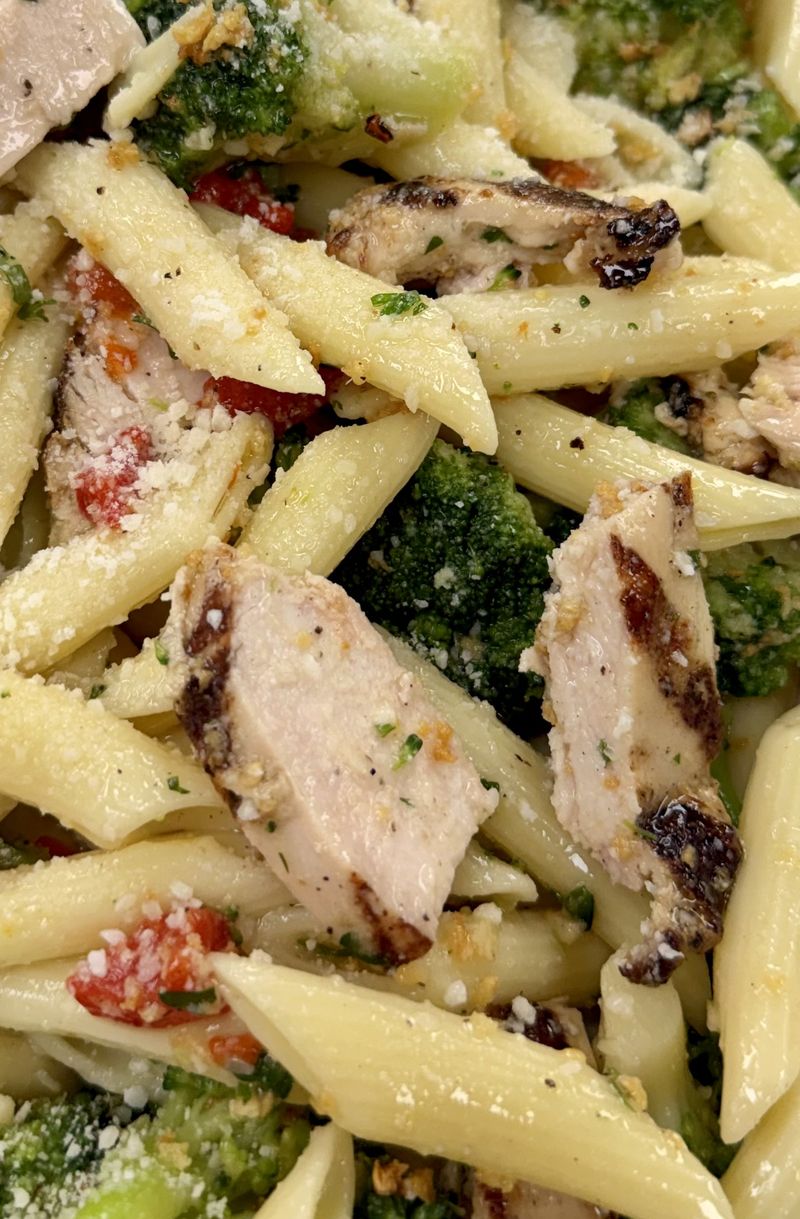 Catering tray of penne with grilled chicken, broccoli and roasted red peppers