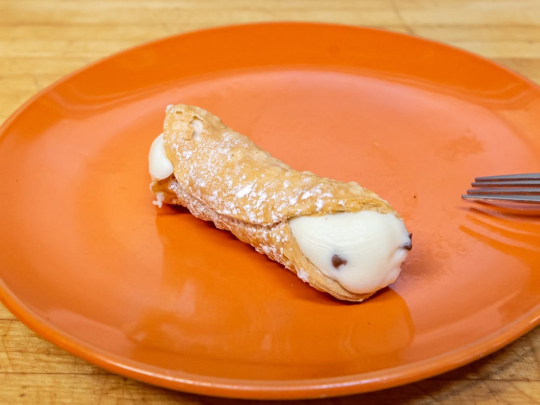 Takeout Menu Frigo's cannoli on a plate
